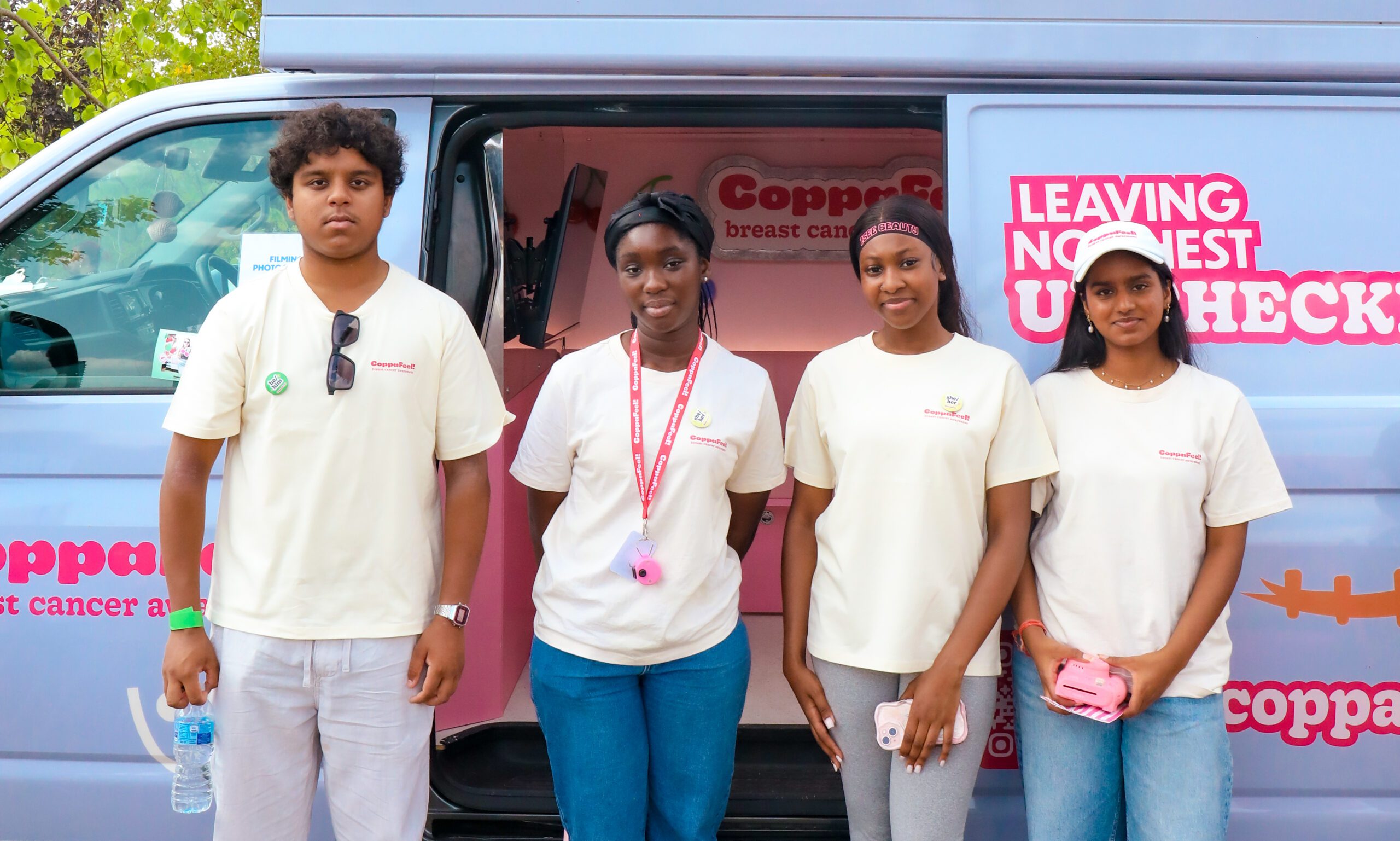Four youth network members stand outside the CoppaFeel! van.